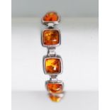 STERLING SILVER AND AMBER BRACELET comprising 10 square links, each collet set with a cabochon