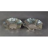 NEAR PAIR OF PIERCED SILVER DISHES, each of shallow, shaped circular form with foliate scroll