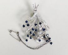 WHITE GOLD COLOURED METAL FLORAL SPRAY BROOCH set with 19 blue sapphires and 42 white sapphires, 2in