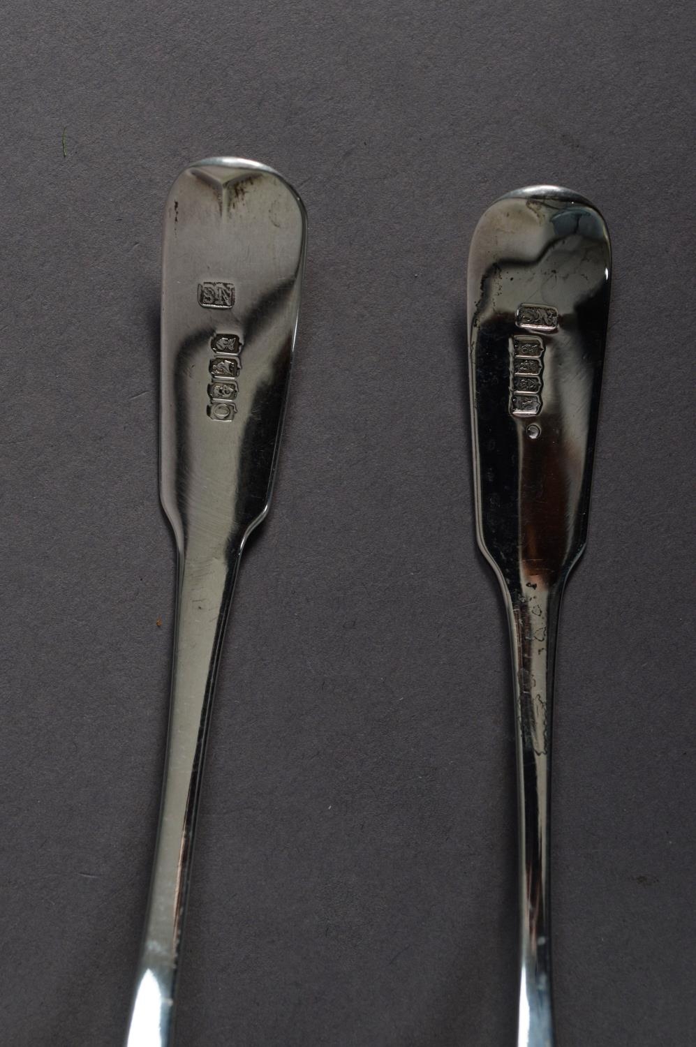 MATCHED PAIR OF GEORGE III IRISH SILVER FIDDLE PATTERN CRESTED SAUCE LADLES with pouring lips by - Image 2 of 2