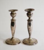 GEORGE V, PAIR OF WEIGHTED AND ENGRAVED SILVER TABLE CANDLESTICKS, with urn shaped sconces with