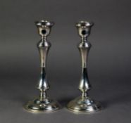PAIR OF SILVER TABLE CANDLESTICKS each with urn shaped sconces, stepped shoulder, waisted column