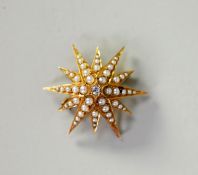 VICTORIAN GOLD EIGHT POINT STAR BROOCH PENDANT set with a centre old cut round diamond,