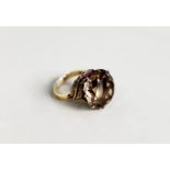 14k LARGE TOPAZ claw set RING, the shank issuing two leaves at the shoulder, 9.2gms
