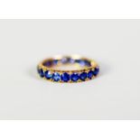 CONTINENTAL GOLD COLOURED METAL ETERNITY RING, set with 20 round cornflower blue sapphires, 2.3 gms,