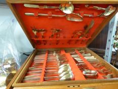 A MODERN WOODEN CASED 78 PIECE CANTEEN OF POLISHED BRONZE CUTLERY, also FOUR SPANISH GOLD PLATED