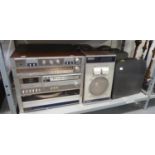 THREE OLD TYPEWRITERS IN CASES AND AN AMSTRAD STEREO SYSTEM WITH SPEAKERS