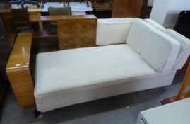 AN UNUSUAL 1930's ART DECO FIGURED WALNUTWOOD CHAISE LONGUE, HAVING BOOKSHELF TO ONE END AND DROP-