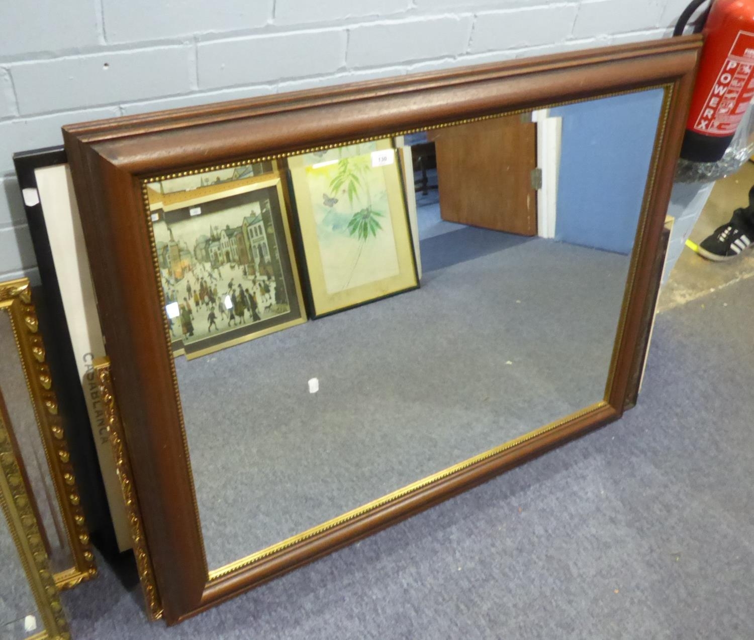 A LARGE DARK WOOD FRAMED BEVELLED EDGE WALL MIRROR, WITH BEADED DECORATION (119cm x 93cm)