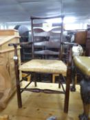 MODERN ELM LADDER BACK OPEN ARMCHAIR, WITH RUSH SEAT, ON POST SUPPORTS