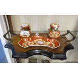 LATE NINETEENTH CENTURY WALNUT AND EBONISED TWO HANDLED DESK STAND, housing a pair of square