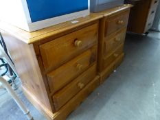 A PAIR OF PINE BEDSIDE CHESTS OF THREE DRAWERS; A CANE LINEN RECEIVER (3)