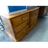 A PAIR OF PINE BEDSIDE CHESTS OF THREE DRAWERS; A CANE LINEN RECEIVER (3)