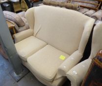A WINGED LOUNGE SUITE OF THREE PIECES, VIZ A TWO SEATER SETTEE AND A PAIR OF WINGED LOUNGE CHAIRS,