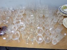 TEN CUT GLASS STEM WINES, IN TWO SIZES (6+4) AND A SET OF TWELVE CUT GLASS BRANDY BALLOONS AND SIX