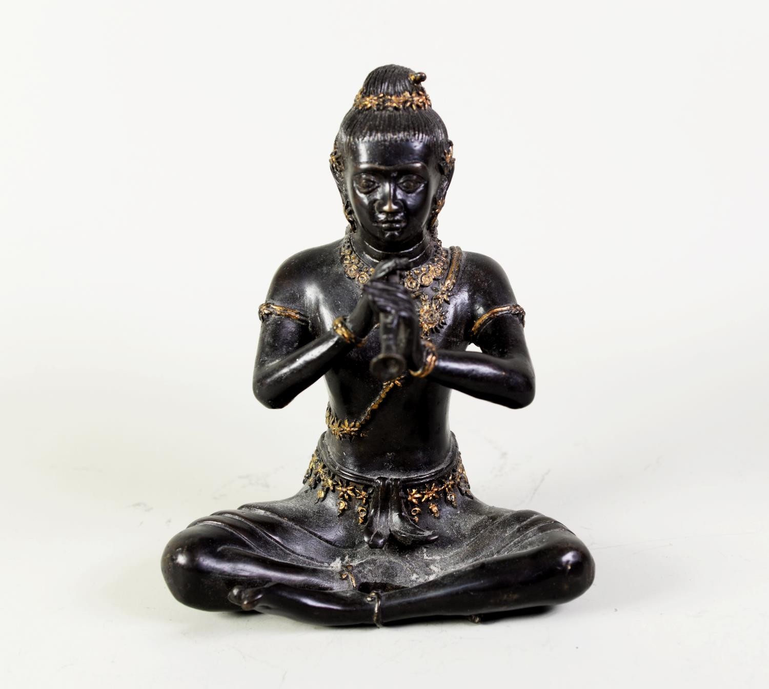 PROBABLY SIAMESE, LATE 19th CENTURY BRONZE FIGURE OF A MAN IN TRADITIONAL COSTUME, with gilt detail,