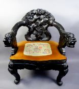 LATE 19th/EARLY 20th CENTURY ORIENTAL CARVED AND EBONISED WOOD TUB CHAIR, the arms carved with scaly