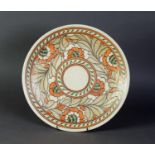 CHARLOTTE RHEAD SIGNED CIRCULAR PLAQUE, flowers and foliage design, in mainly orange, fawn, scroll