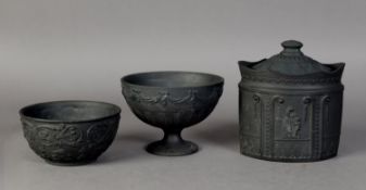 TWO NINETEENTH CENTURY WEDGWOOD BLACK BASALT SUGAR BOWLS, one of pedestal form with swagged