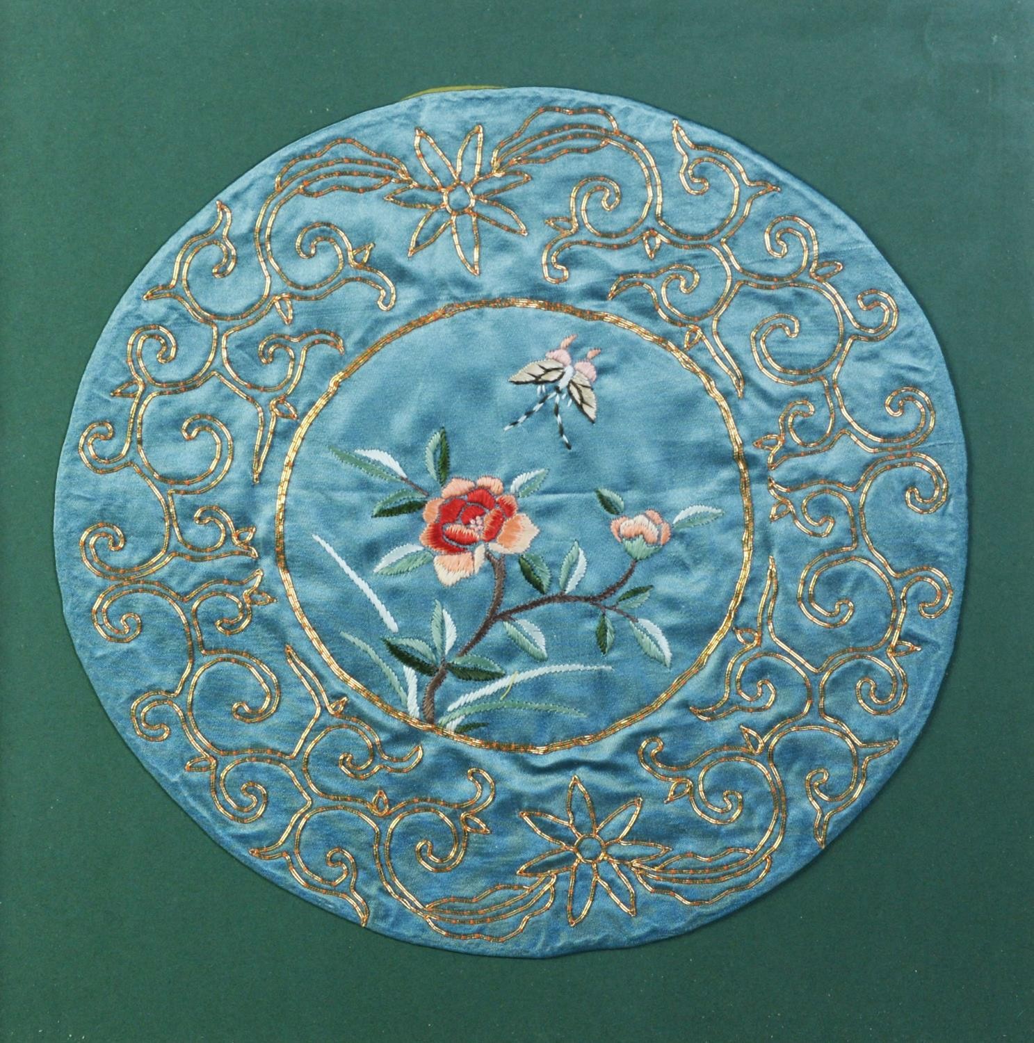 SIX CHINESE SILK NEEDLEWORK CIRCULAR PANELS, centred with flowers within a gilt foliate scroll