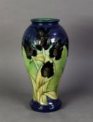 WALTER MOORCROFT BLACK TULIP PATTERN TUBE LINED POTTERY VASE BY SALLY TUFFIN, of baluster form,