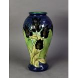 WALTER MOORCROFT BLACK TULIP PATTERN TUBE LINED POTTERY VASE BY SALLY TUFFIN, of baluster form,