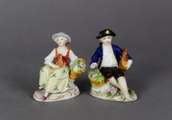 PAIR OF SITZENDORF PORCELAIN SMALL FIGURES, each painted in colours and gilt and modelled seated,