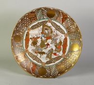 JAPANESE MEIJI PERIOD KIOTO SATSUMA SHALLOW DISH, enamelled and richly gilt with seven figures, 12