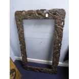 LATE NINETEENTH CENTURY JAPANESE CARVED AND PIERCED EBONISED WOOD BROAD PICTURE FRAME, relief carved