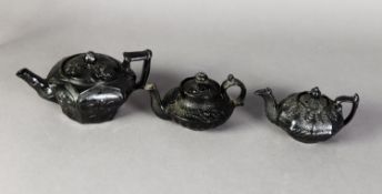 THREE SMALL NINETEENTH CENTURY BLACK SMEAR GLAZED AND MOULDED TEAPOTS, including one in the Oriental