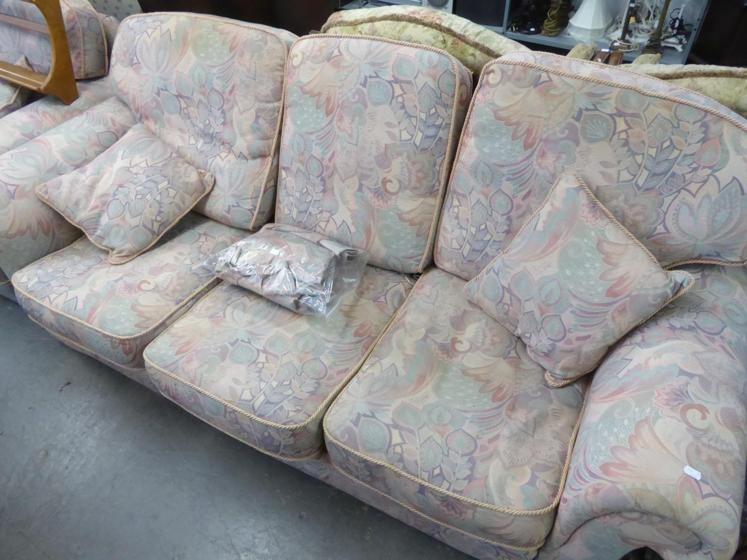 A LOUNGE SUITE OF FOUR PIECES, COVERED IN PASTEL PINK AND BLUE FLORAL FABRIC, VIZ A THREE SEATER