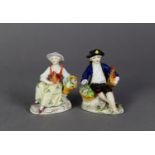 PAIR OF SITZENDORF PORCELAIN SMALL FIGURES, each painted in colours and gilt and modelled seated,