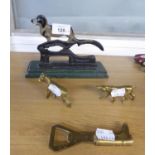 A CAST AND PAINTED BLACK METAL TABLE TOP NUTCRACKER WITH DOG SURMOUNTING; A BRASS BOOT HANDLED