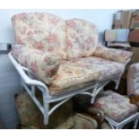 A WHITE ENAMELLED BAMBOO CONSERVATORY TWO SEATER SETTEE WITH OUT-SCROLLED ARMS AND SIX LOOSE BACK,