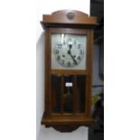 OAK WELLINGTON WALL CLOCK, WITH SILVERED ARABIC DIAL AND BEVELLED GLASS PANELS