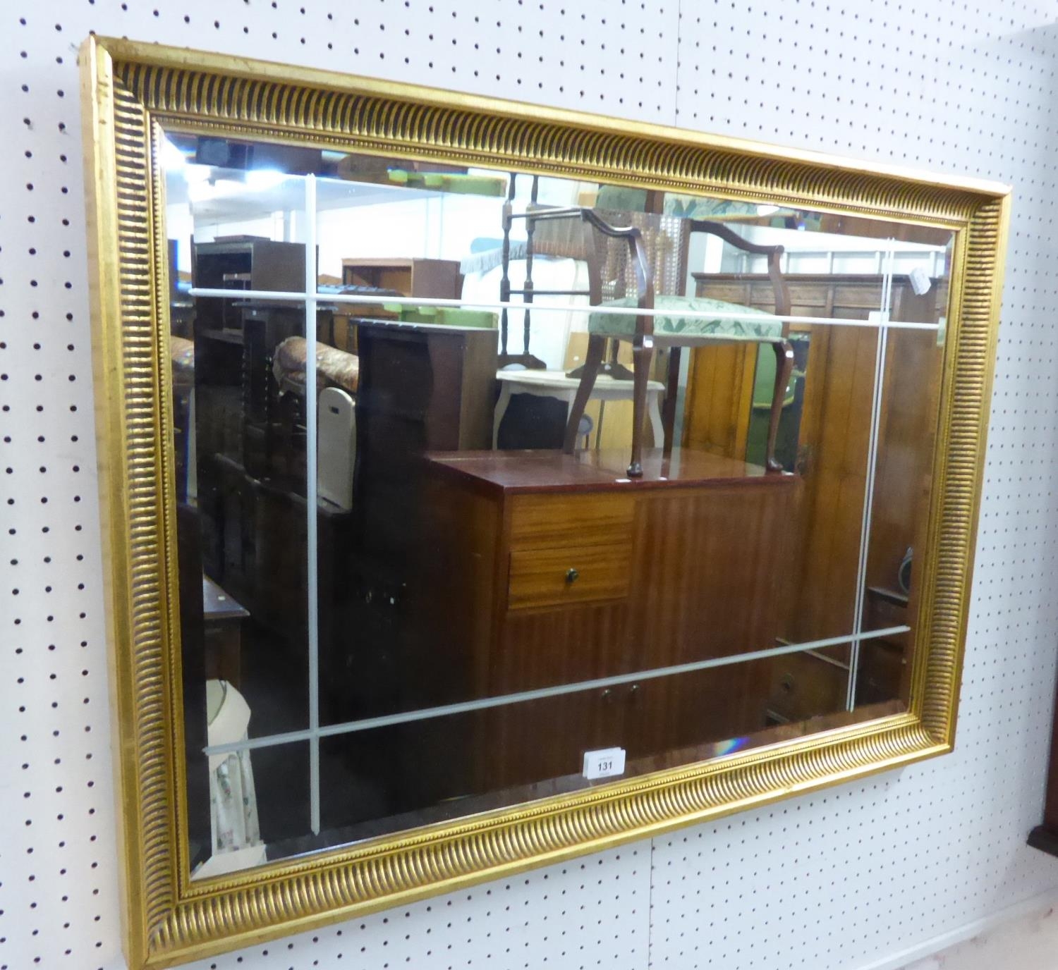 RECTANGULAR BEVELLED EDGE WALL MIRROR, WITH CUT-LINE DECORATION, IN FLUTED CAVETTO GILT FRAME, 1'11"