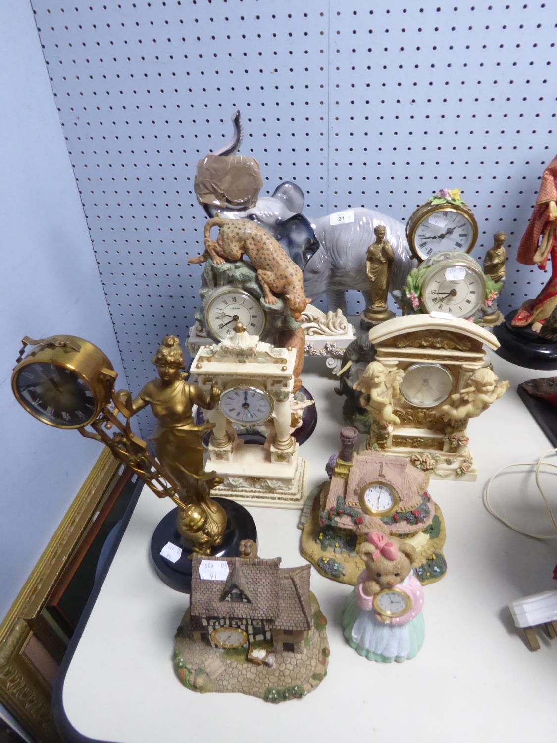 TWO MODERN GILT METAL FIGURAL MANTLE CLOCKS, NINE COMPOSITION MANTLE CLOCKS, and a POTTER EXAMPLE