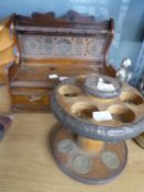 AN OAK AND BRASS SMOKER’S PIPE RACK WITH DRAWER IN THE BASE; A RO-EL CARVED OLIVE WOOD FIVE DIVISION