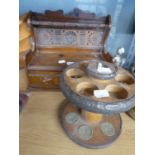 AN OAK AND BRASS SMOKER’S PIPE RACK WITH DRAWER IN THE BASE; A RO-EL CARVED OLIVE WOOD FIVE DIVISION