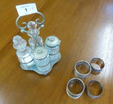 THREE HALLMARKED SILVER NAPKIN RINGS, including two floral engraved examples, ANOTHER IN E.P, and an