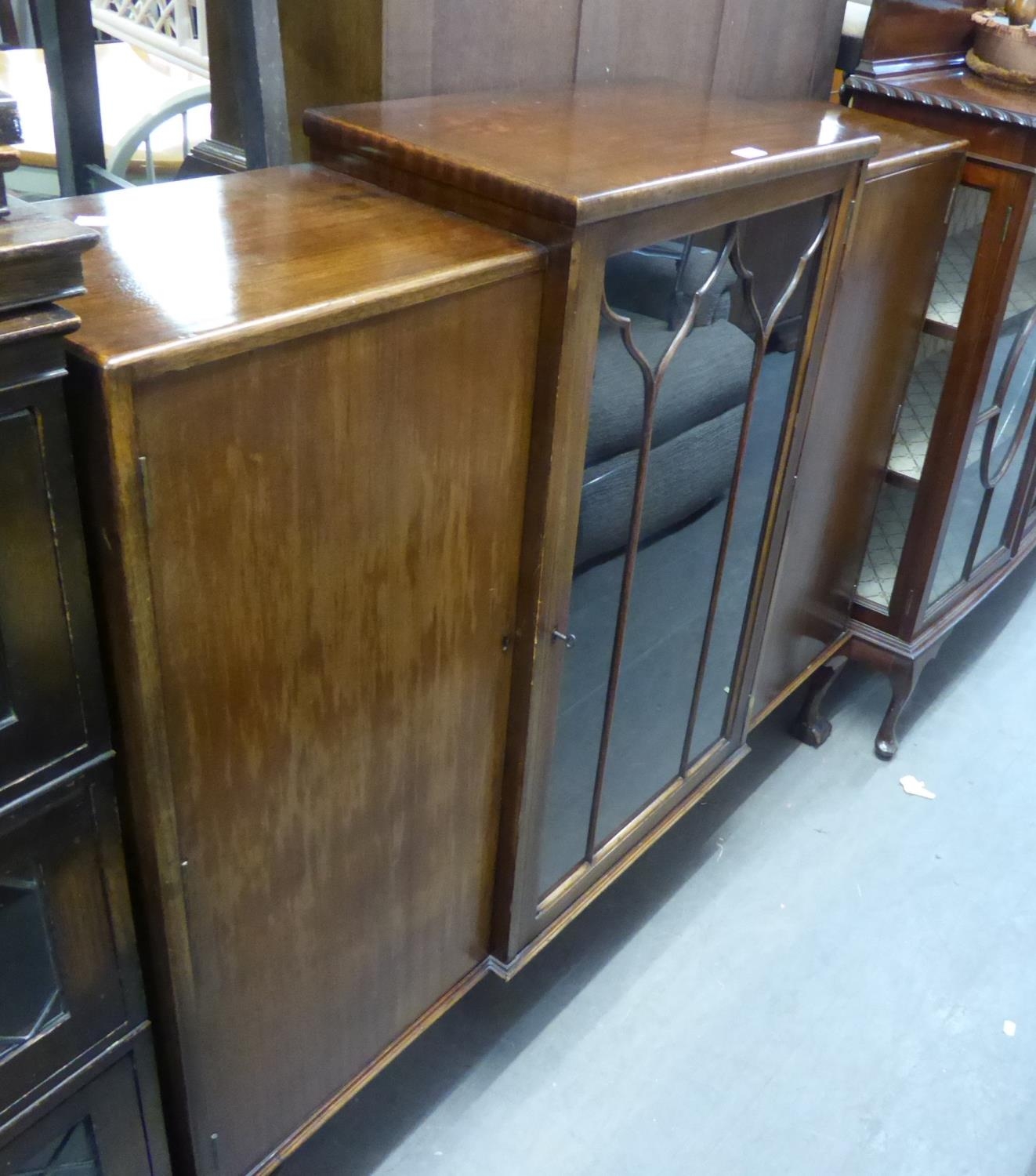 A WALNUTWOOD DISPLAY CABINET, HAVING STEPPED TOP