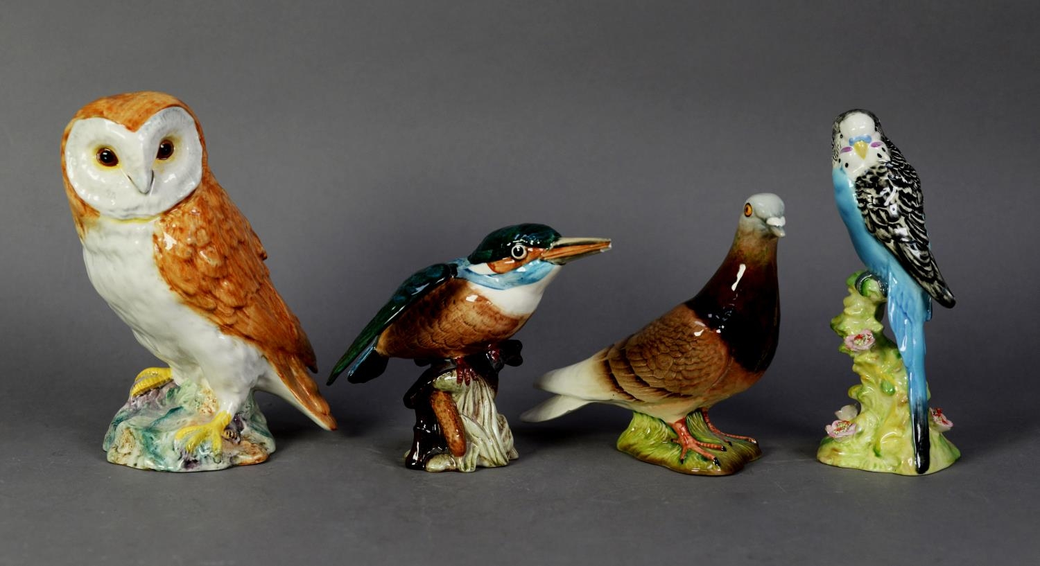 FOUR BESWICK POTTERY MODELS OF BIRDS, comprising: BARN OWL (1046), PIGEON (1383), BLUE BUDGIE (1216)