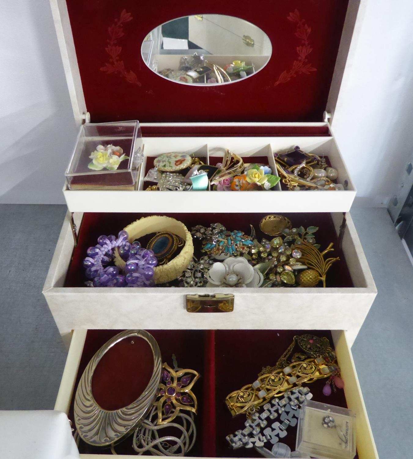 AN AUTOMATIC OPENING THREE TIER JEWELLERY CASE WITH A QUANTITY OF COSTUME JEWELLERY MAINLY