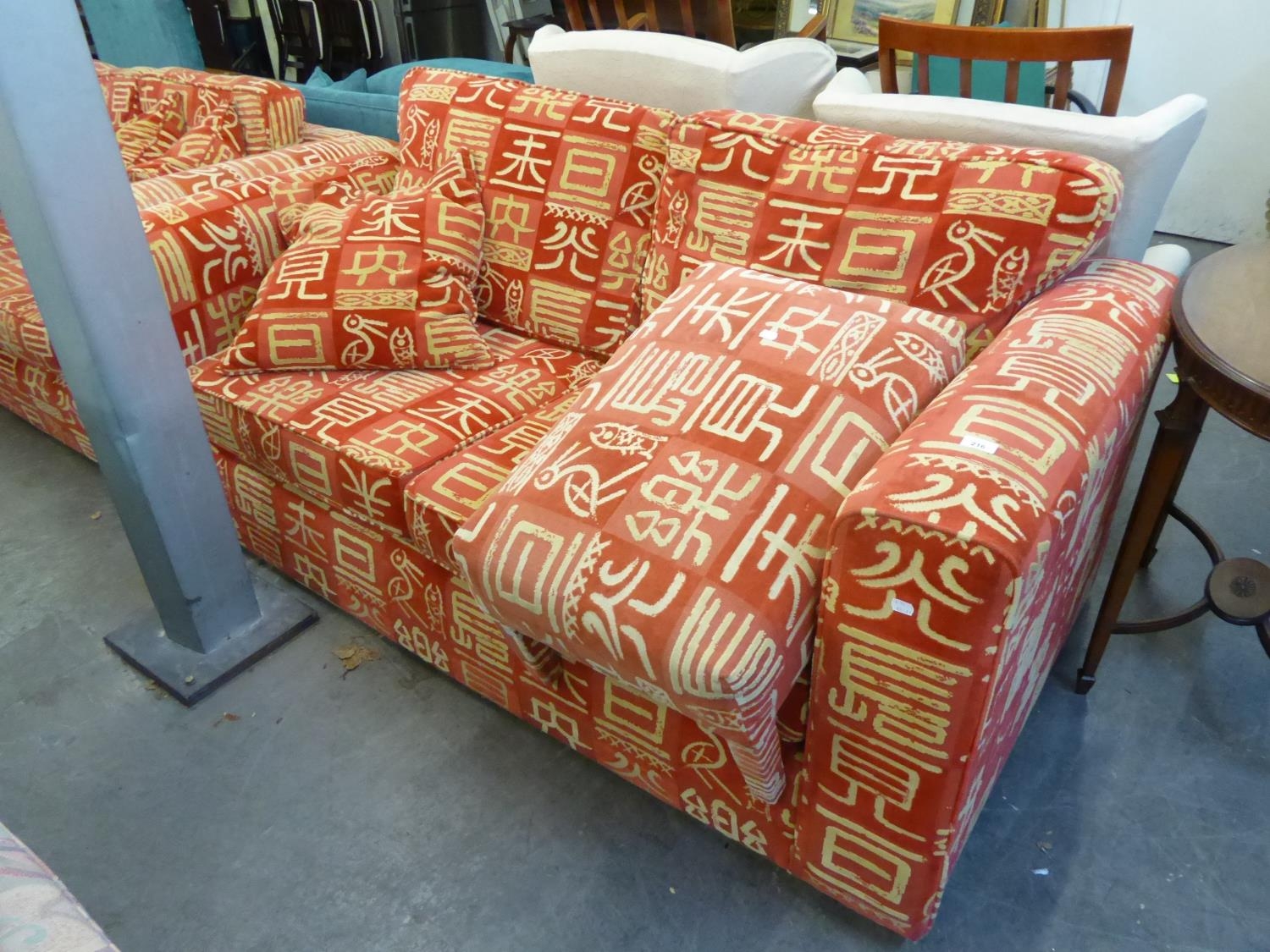 A LOUNGE SUITE OF 3 PIECES, COVERED IN RED FABRIC, EMBOSSED WITH WHITE ORIENTAL CHARACTERS, VIZ, A