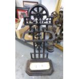BLACK PAINTED CAST IRON STICK OR UMBRELLA STAND, WITH PIERCED BACK CAST WITH A SUNBURST AND CREAM