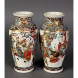 PAIR OF EARLY TWENTIETH CENTURY JAPANESE PORCELAIN WALL PLAQUES, decorated in polychrome enamels