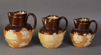 GRADUATED SET OF THREE ROYAL DOULTON SALT GLAZED STONEWARE JUG, sprigged with toping scenes, 6”,