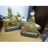 A PAIR OF CAST BRASS EQUESTRIAN FIGURE HEARTH ORNAMENTS OR DOOR STOPS, ON BLACK CAST IRON BASES