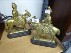 A PAIR OF CAST BRASS EQUESTRIAN FIGURE HEARTH ORNAMENTS OR DOOR STOPS, ON BLACK CAST IRON BASES