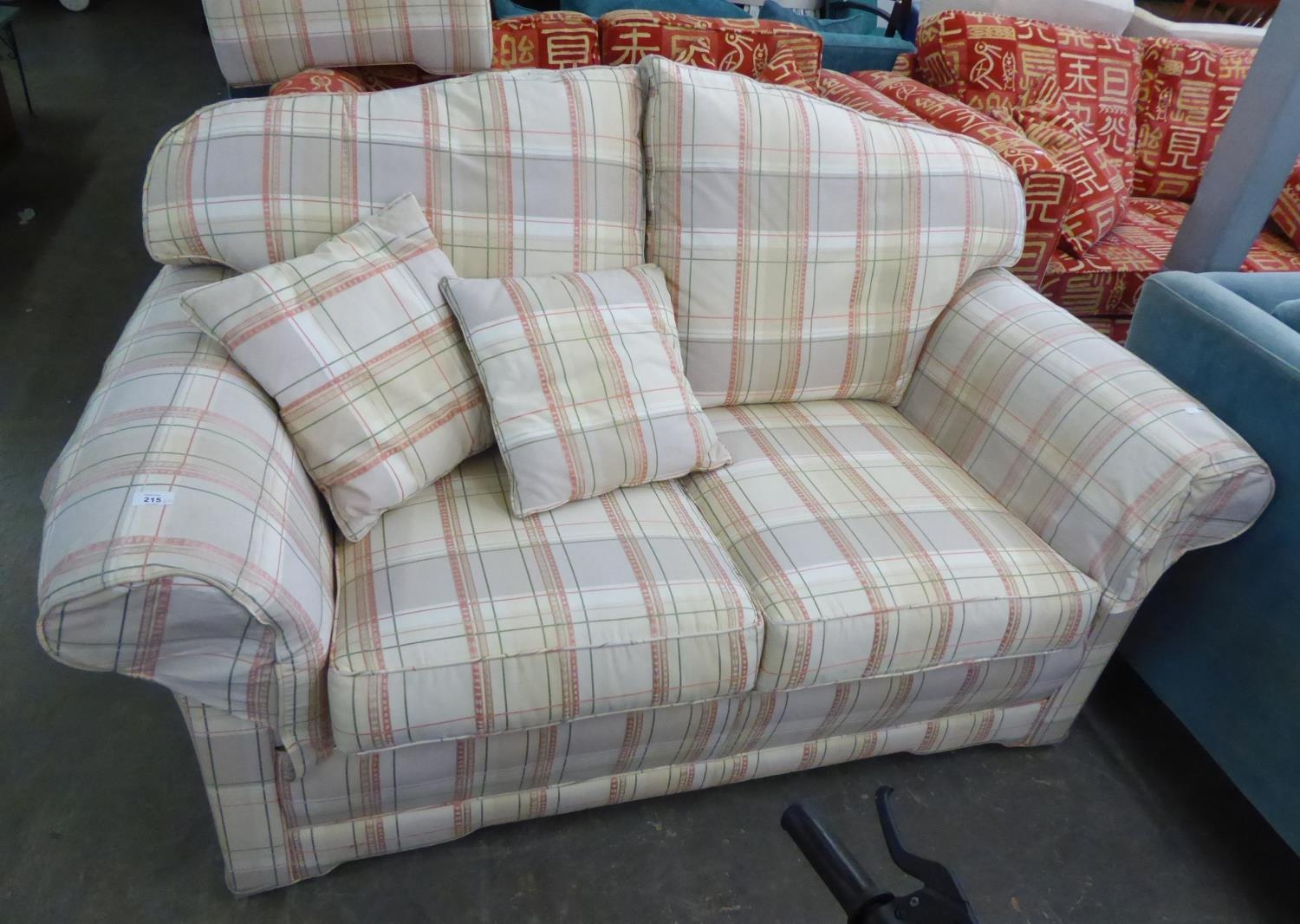A TWO SEATER SETTEE, COVERED IN CHECK FABRIC AND THE MATCHING FOOTSTOOL (2)
